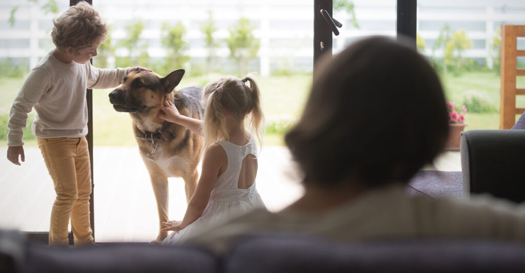 two girls playing with dog